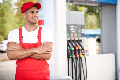 Photo of Worker in uniform at modern gas station