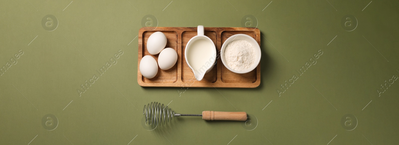 Image of Metal whisk, eggs, milk and flour on khaki background, top view. Banner design