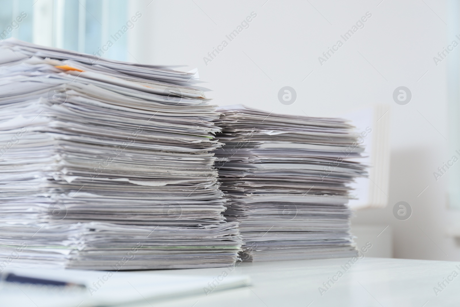 Photo of Stacks of documents on table in office