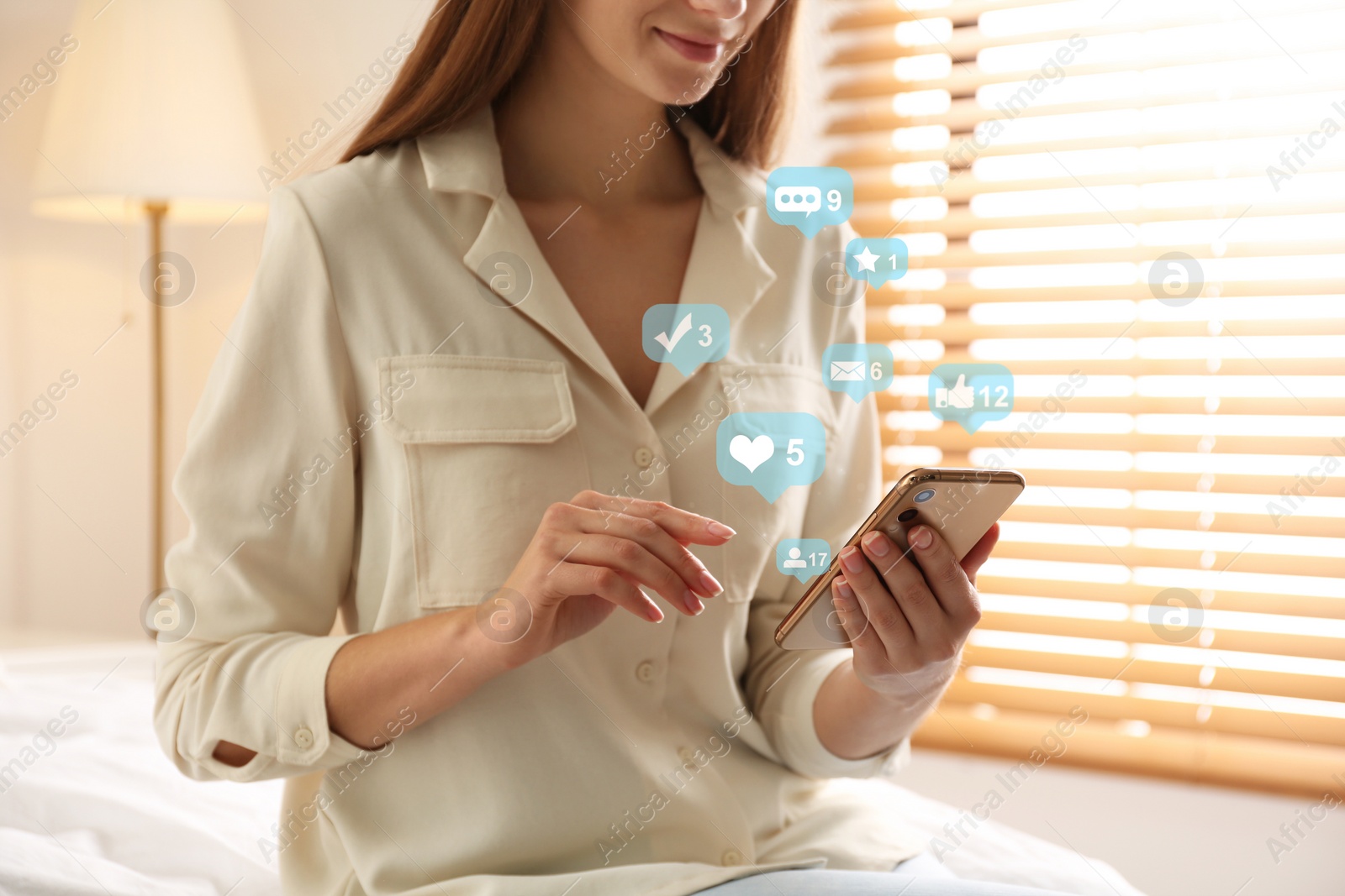 Image of Young woman using modern smartphone at home, closeup