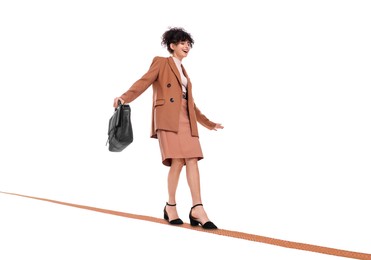 Image of Businesswoman walking rope against white background. Risk or balance concept