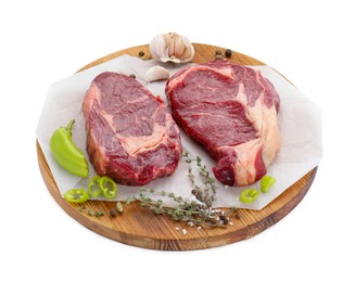 Photo of Pieces of beef meat with thyme and spices on white background