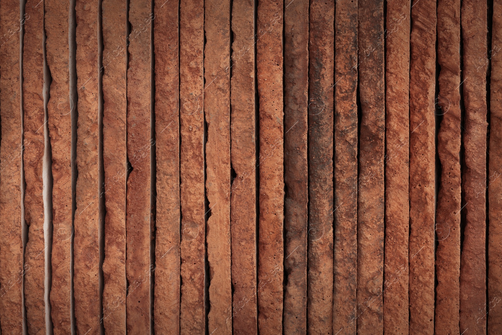 Photo of Many decorative bricks stacked as background, top view. Tiles installation process