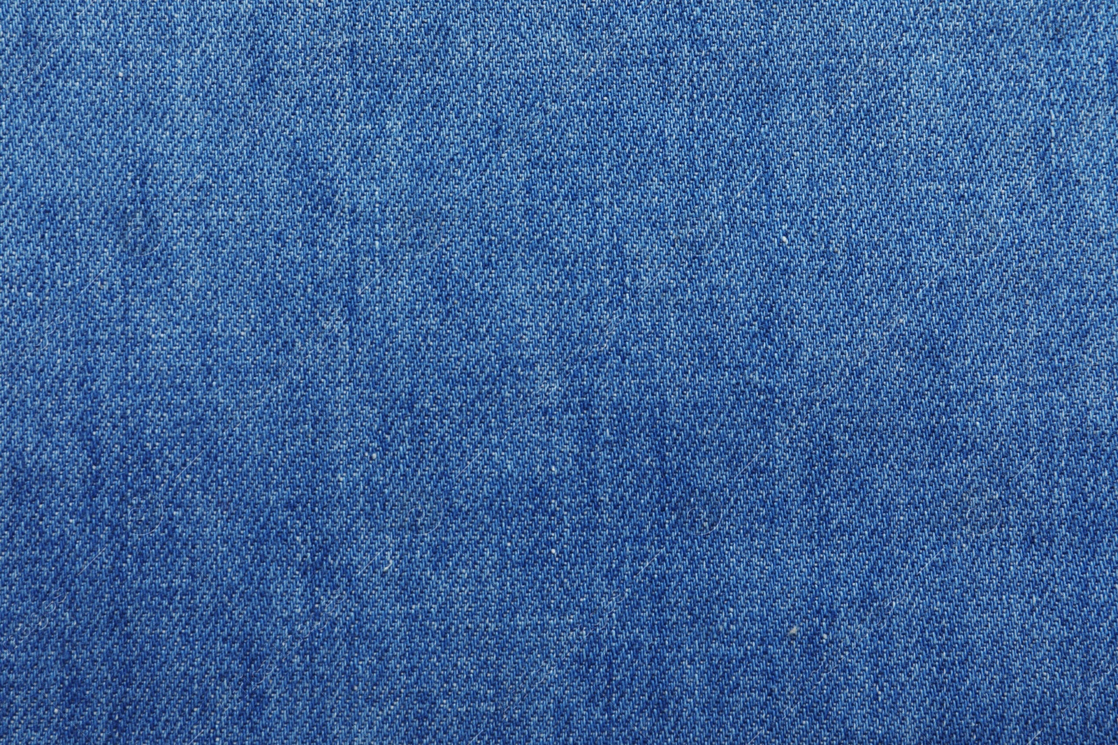 Photo of Texture of blue jeans as background, closeup