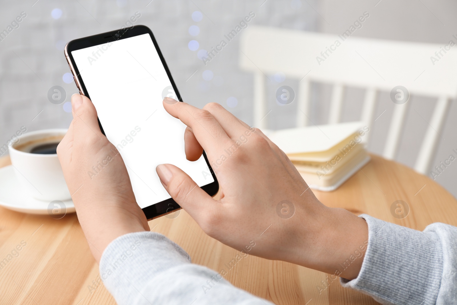 Photo of Young woman using new modern smartphone in cafe, closeup