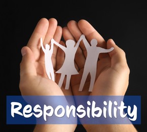 Image of Roles and Responsibilities. Man holding paper silhouette of family in hands on black background, closeup
