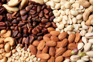 Photo of Organic mixed nuts as background, top view