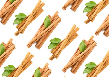 Set with aromatic cinnamon sticks on white background, top view