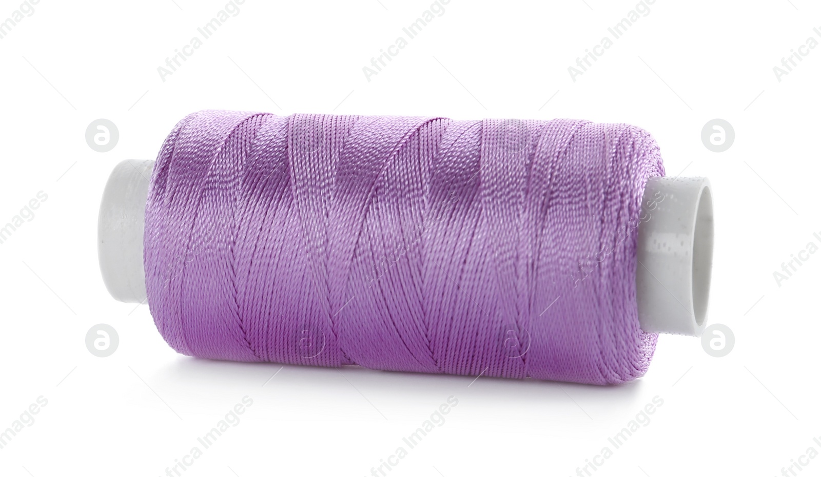 Photo of Spool of violet sewing thread isolated on white