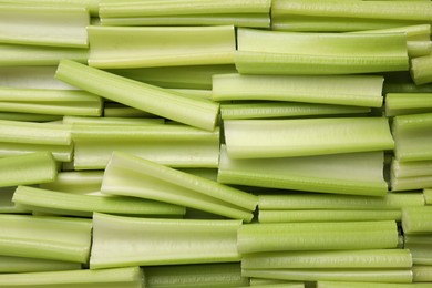 Fresh green cut celery as background, top view