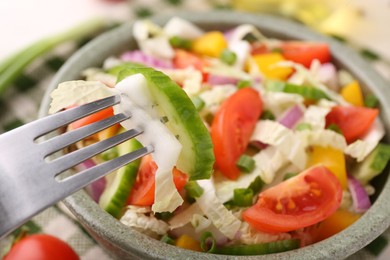 Photo of Eating delicious salad with Chinese cabbage at table, closeup