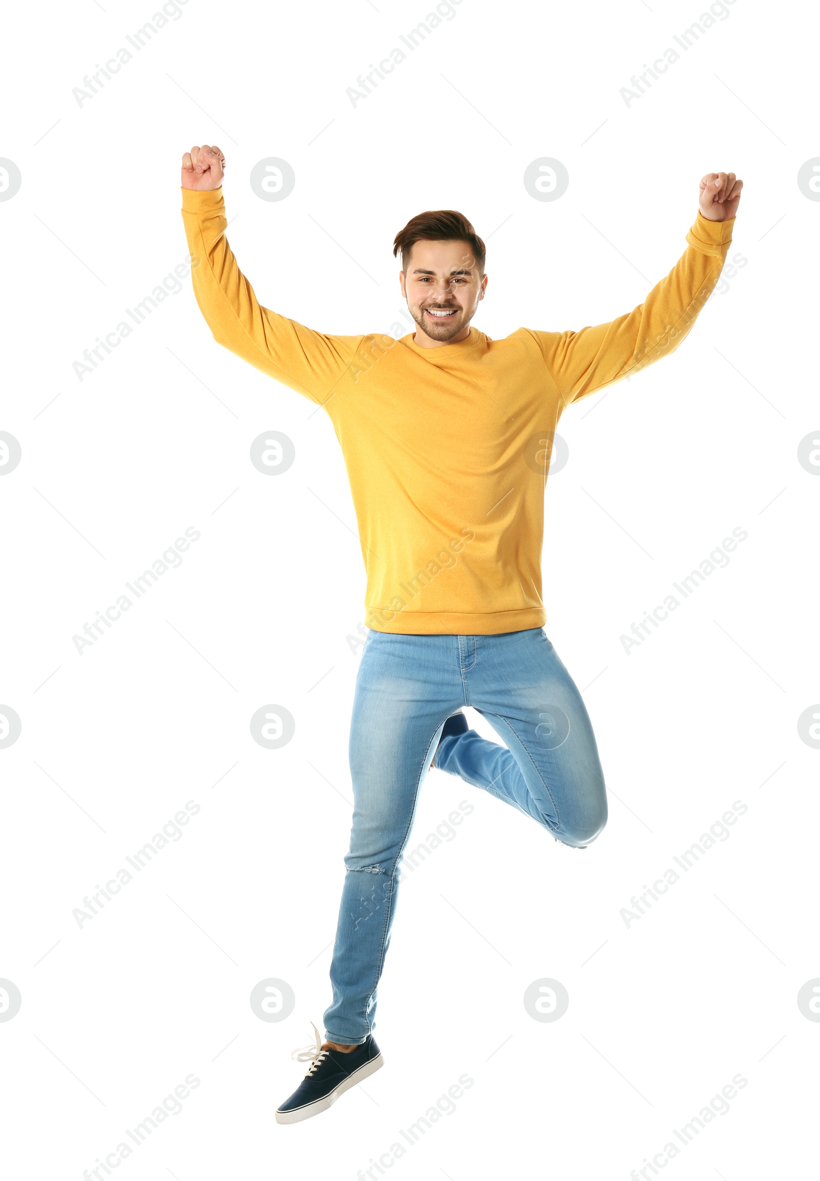 Photo of Full length portrait of happy handsome man jumping on white background