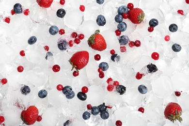 Photo of Frozen berries and ice cubes as background