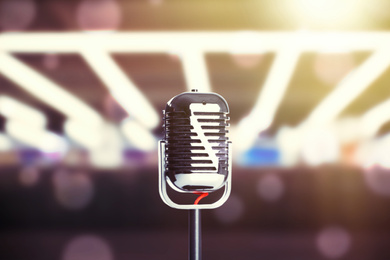 Image of Vintage microphone in karaoke club, bokeh effect