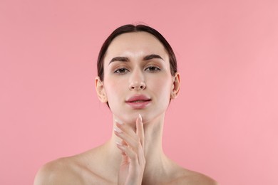 Photo of Portrait of beautiful young woman on pink background