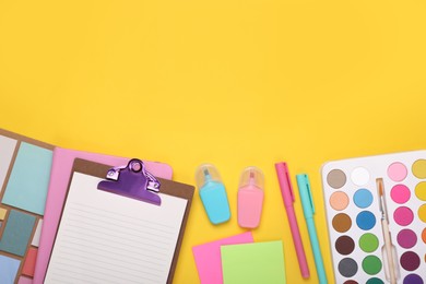 Flat lay composition with different school stationery on yellow background, space for text. Back to school