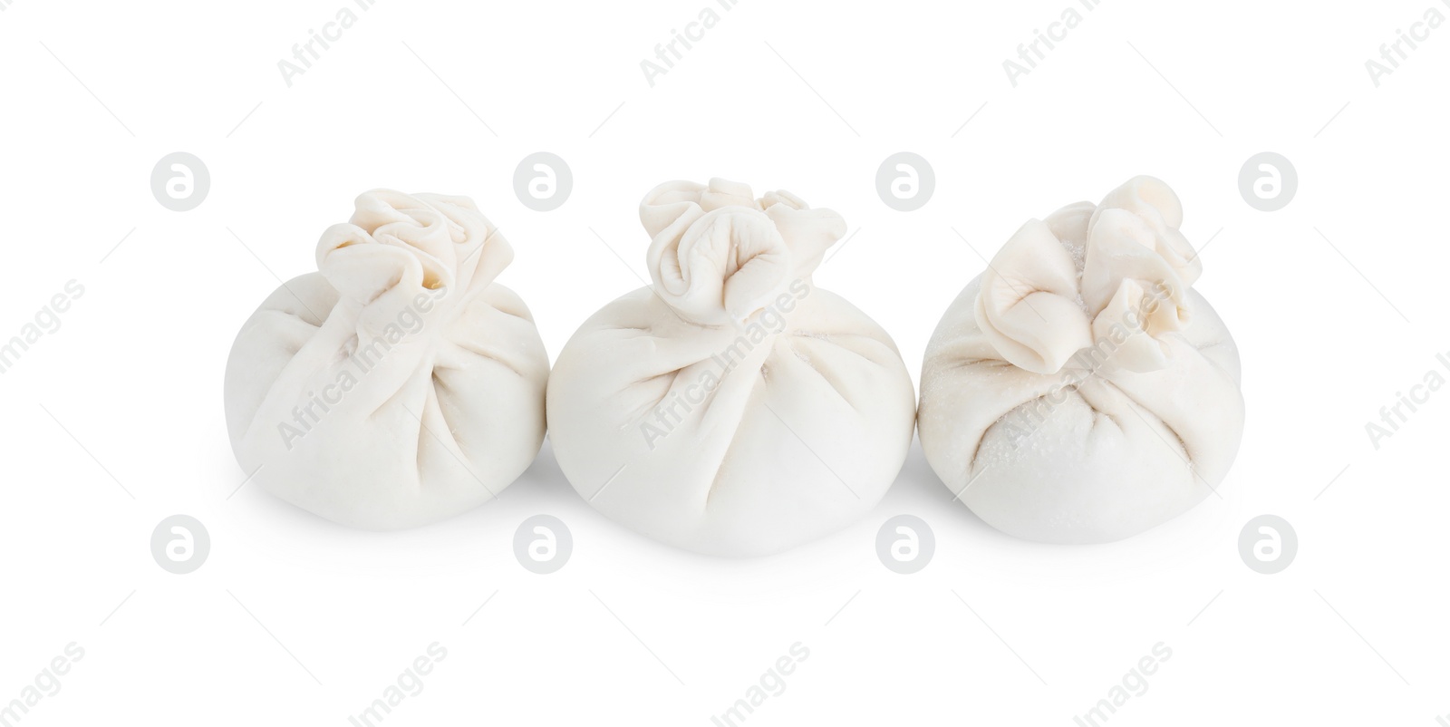 Photo of Uncooked khinkali (dumplings) isolated on white. Georgian cuisine