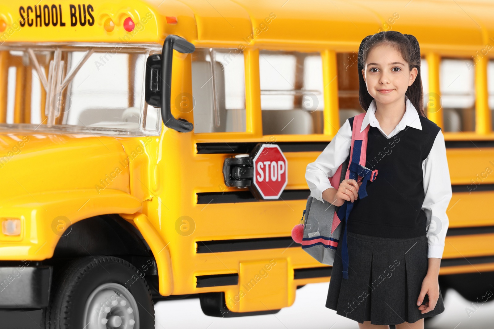 Image of Girl with backpack near yellow school bus. Transport for students