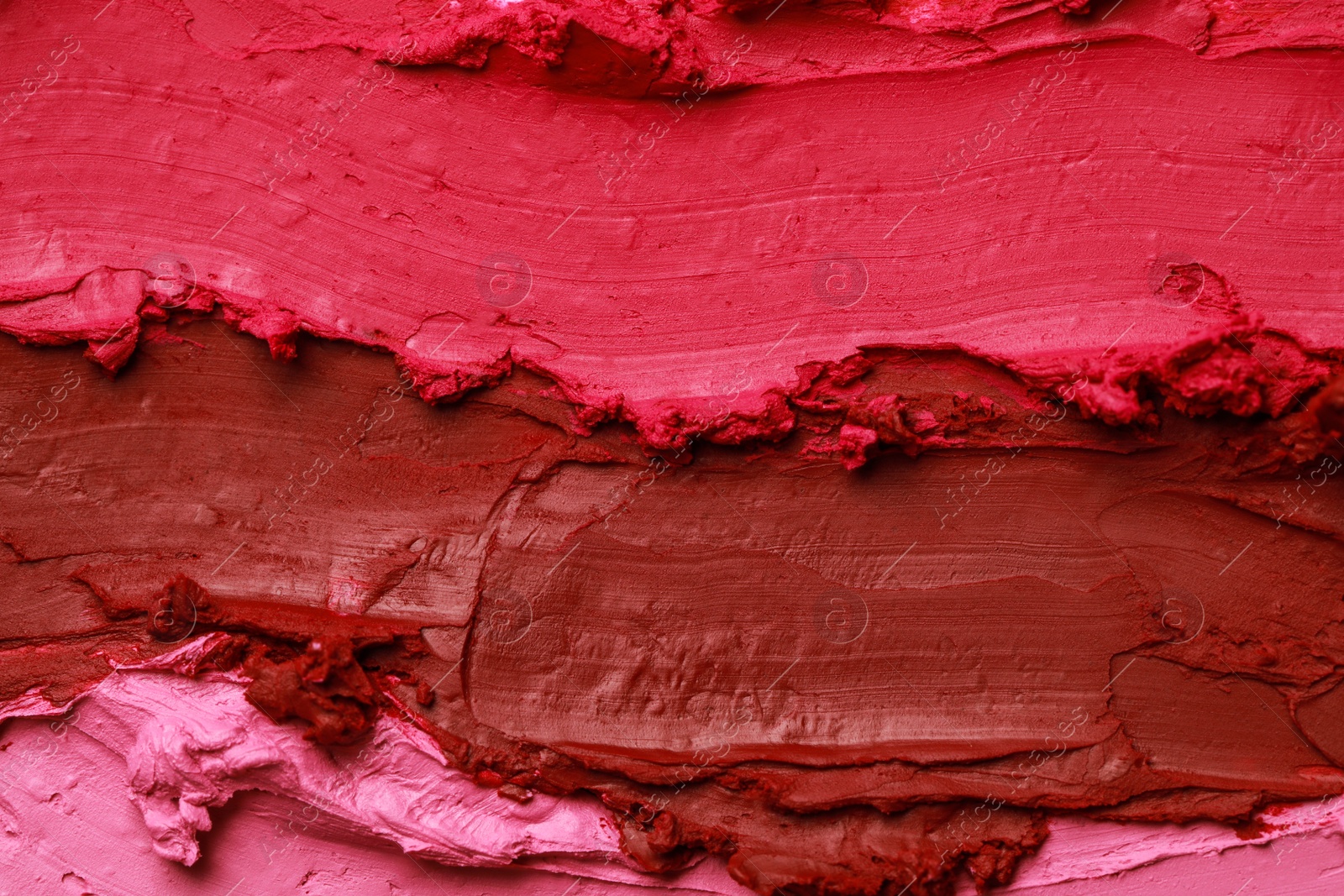 Photo of Texture of beautiful lipsticks as background, top view