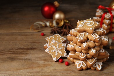 Photo of Tasty Christmas cookies on wooden table, space for text