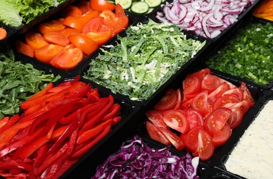 Photo of Salad bar with different fresh ingredients as background