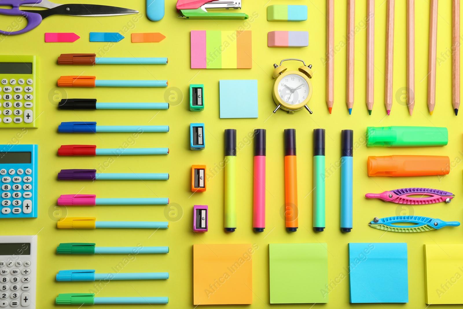 Photo of Flat lay composition with school stationery on yellow background. Back to school