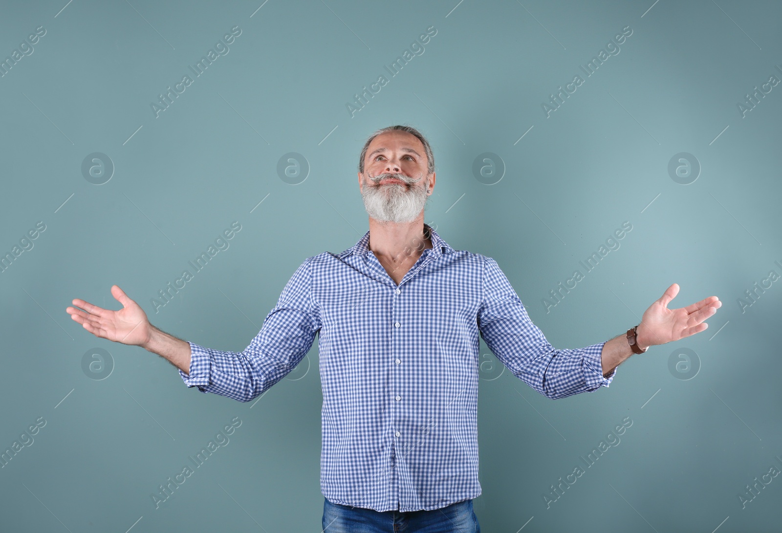 Photo of Portrait of handsome mature man on color background