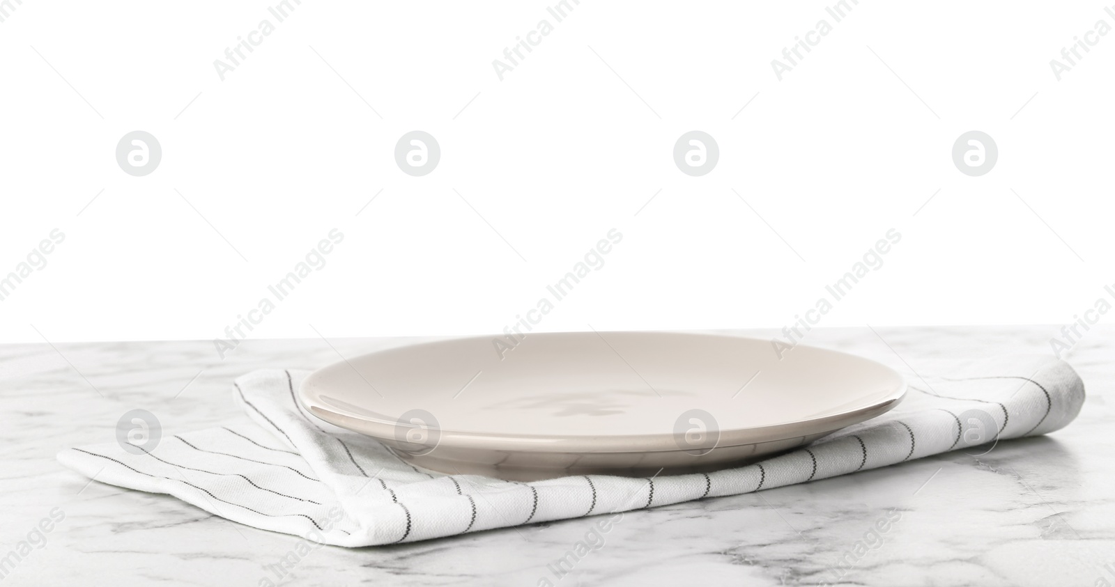 Photo of Empty grey plate and napkin on marble table against white background