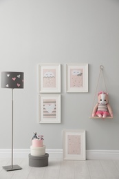 Children's room interior with floor lamp and cute pictures on wall