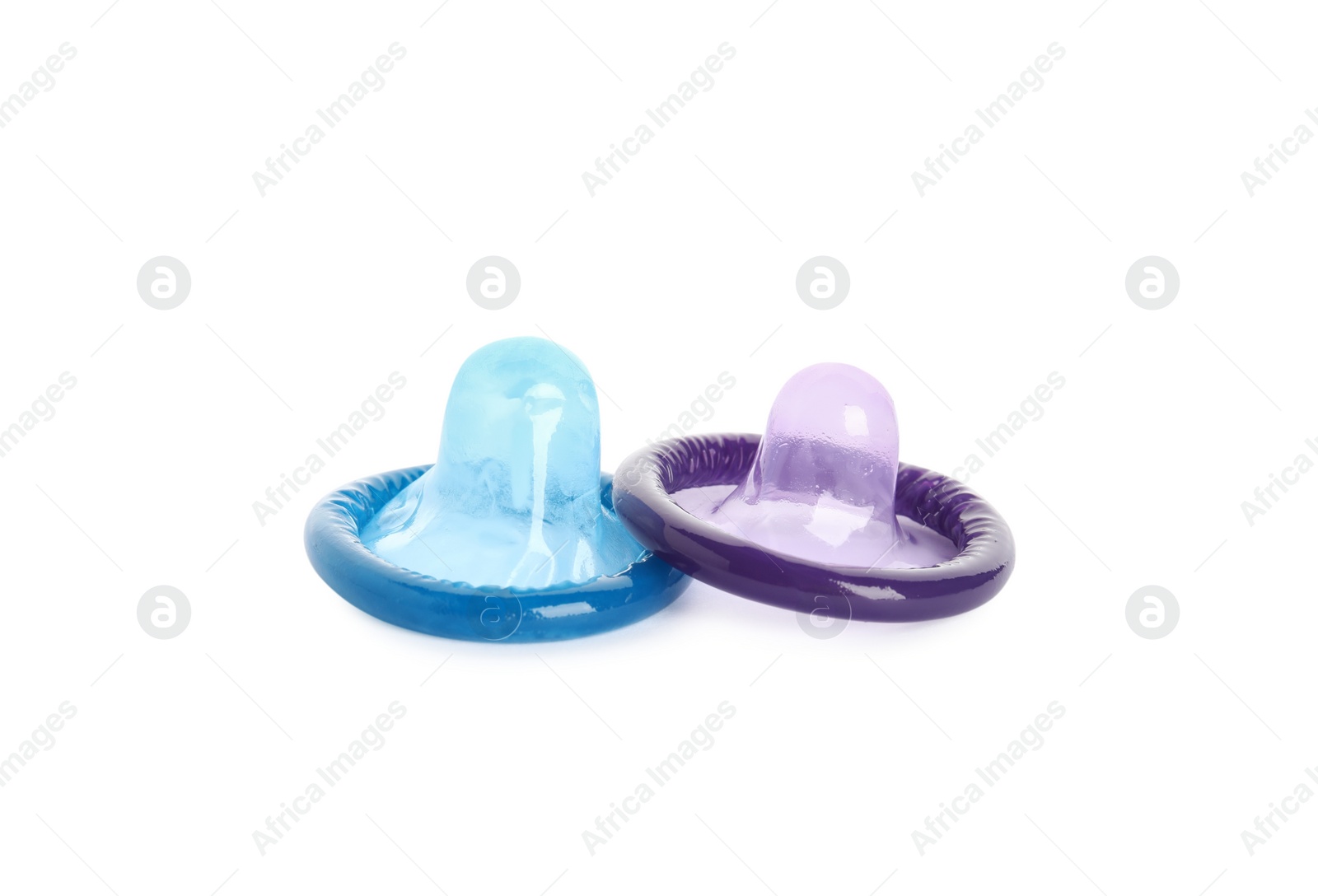 Photo of Unpacked colorful condoms on white background. Safe sex