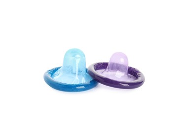 Unpacked colorful condoms on white background. Safe sex