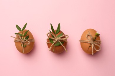 Festively decorated chicken eggs on pink background, flat lay. Happy Easter