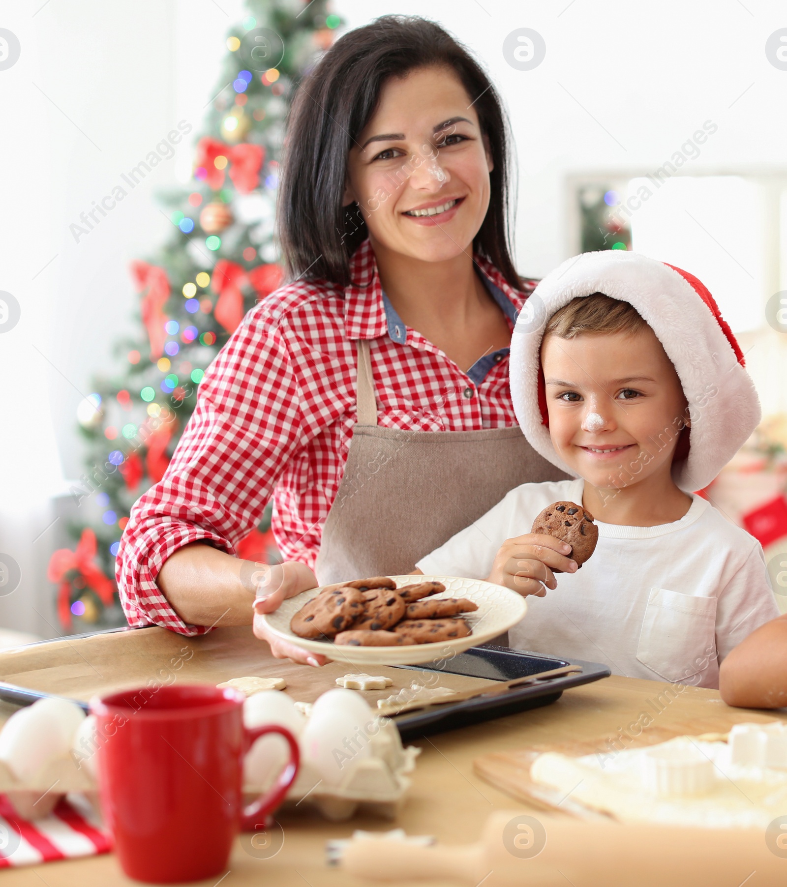 Photo of Mother and children making Christmas cookies together at home