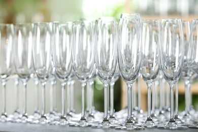 Empty glasses on wooden table against blurred background