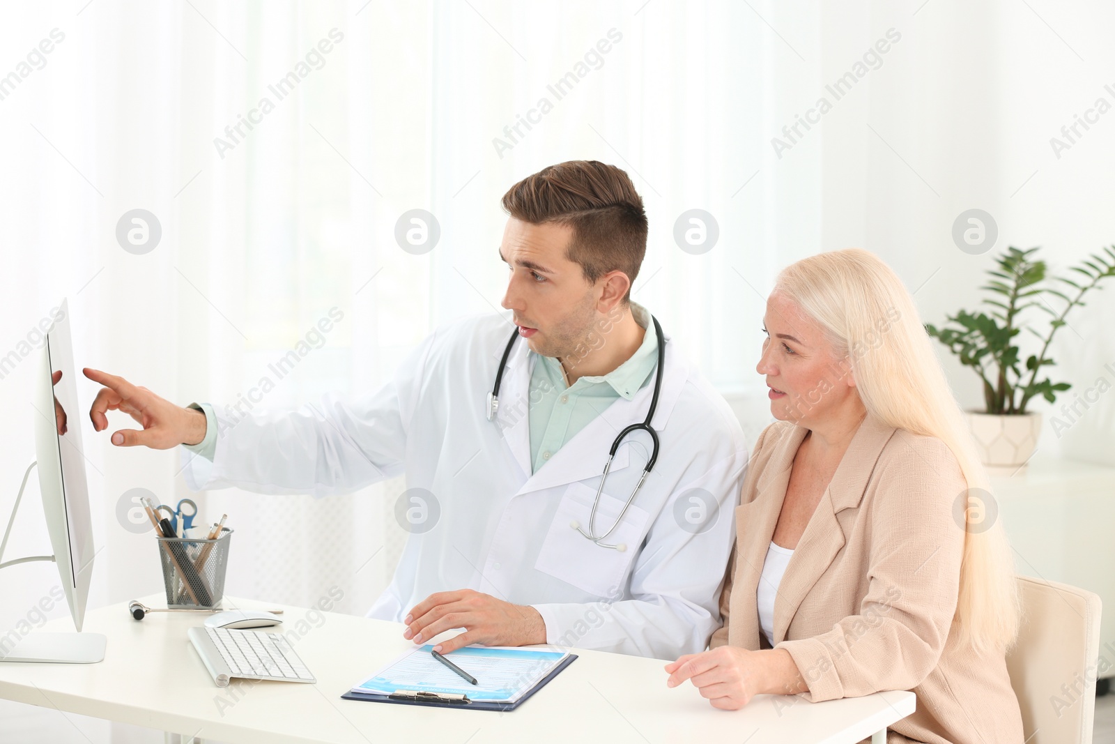 Photo of Doctor working with mature patient in hospital