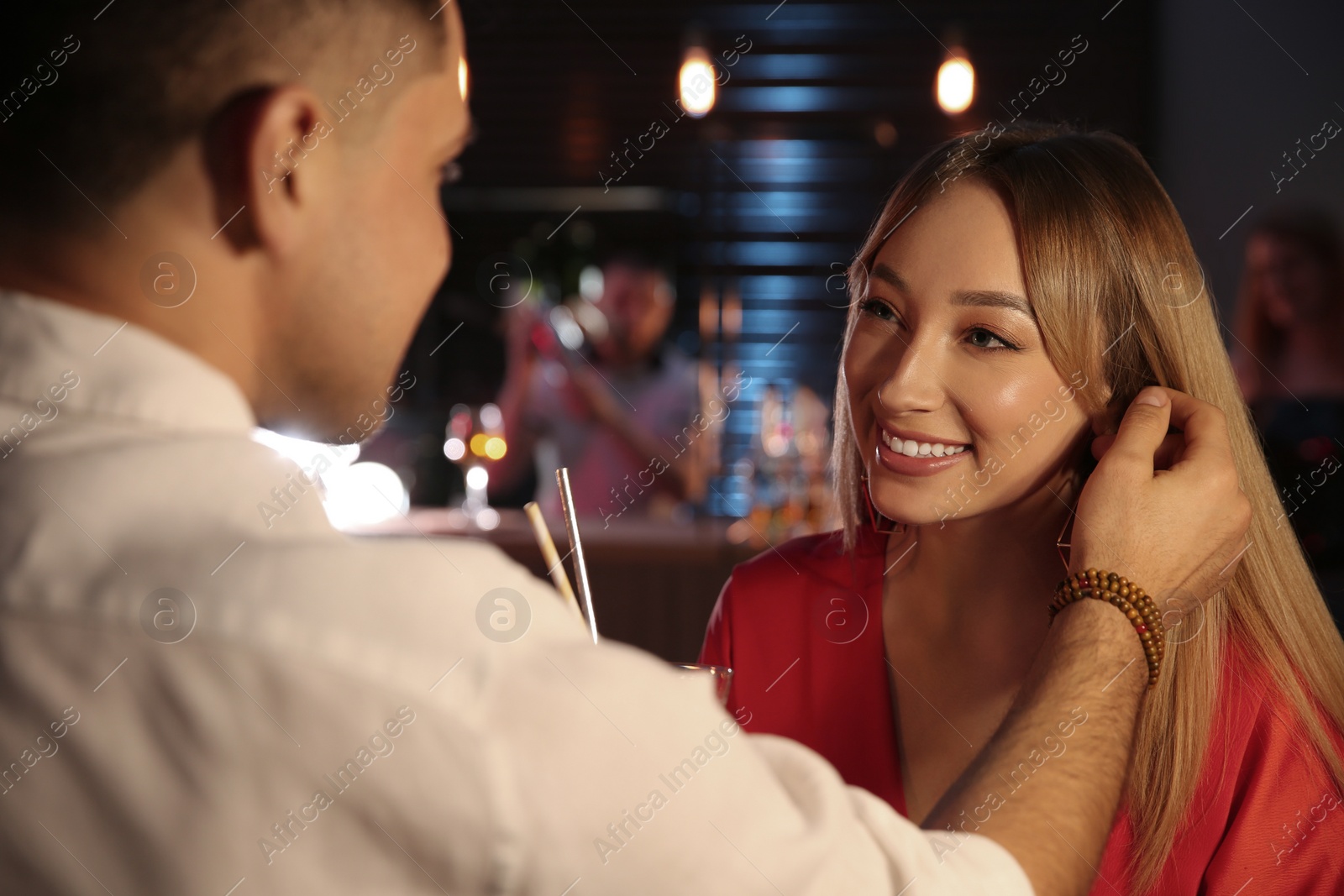 Photo of Man and woman flirting with each other in bar