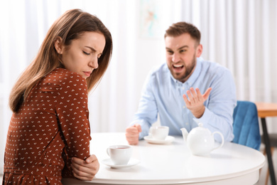 Couple having quarrel in cafe. Relationship problems