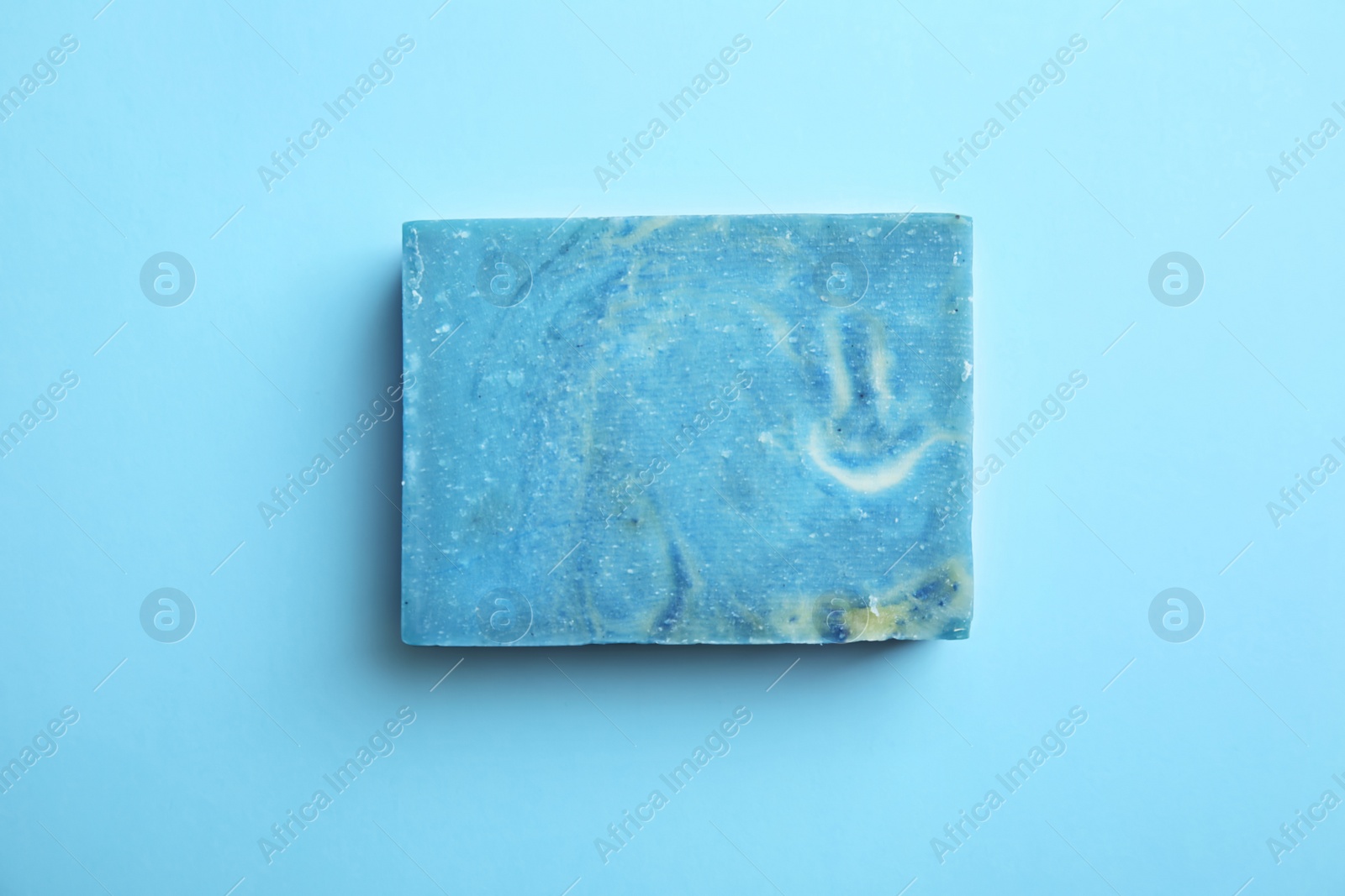 Photo of Hand made soap bar on color background, top view