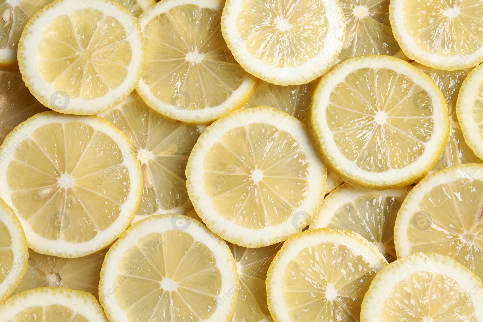 Photo of Slices of fresh lemons as background, top view