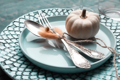 Photo of Autumn table setting with pumpkin on blue background, closeup