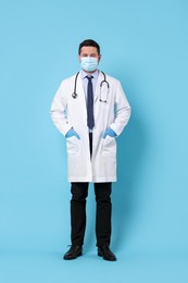 Photo of Doctor in medical mask on light blue background