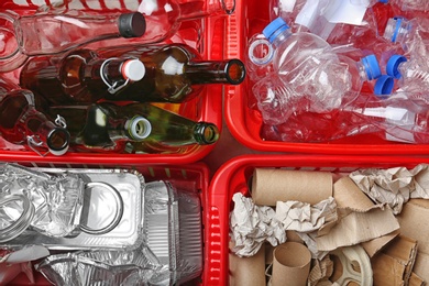 Photo of Crates with assorted garbage, top view. Trash recycling