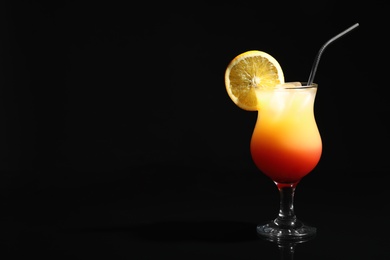 Photo of Just made appetizing cocktail Sex on the Beach, black background. Space for text