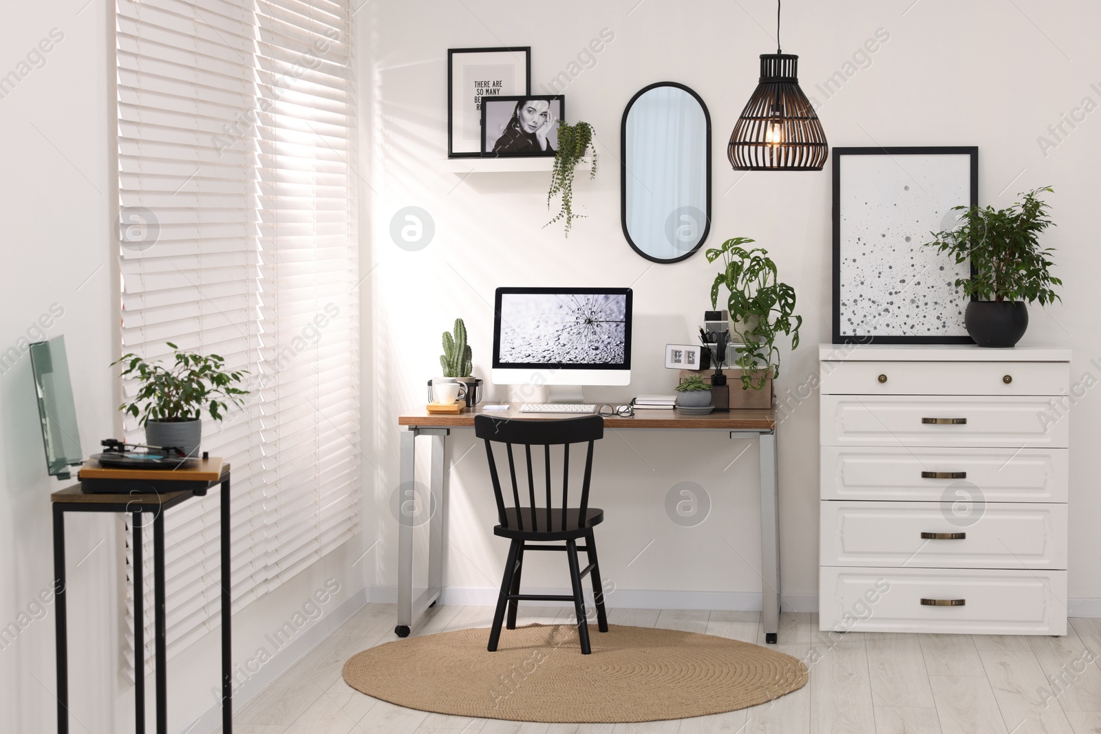 Photo of Cozy workspace with computer on wooden desk at home