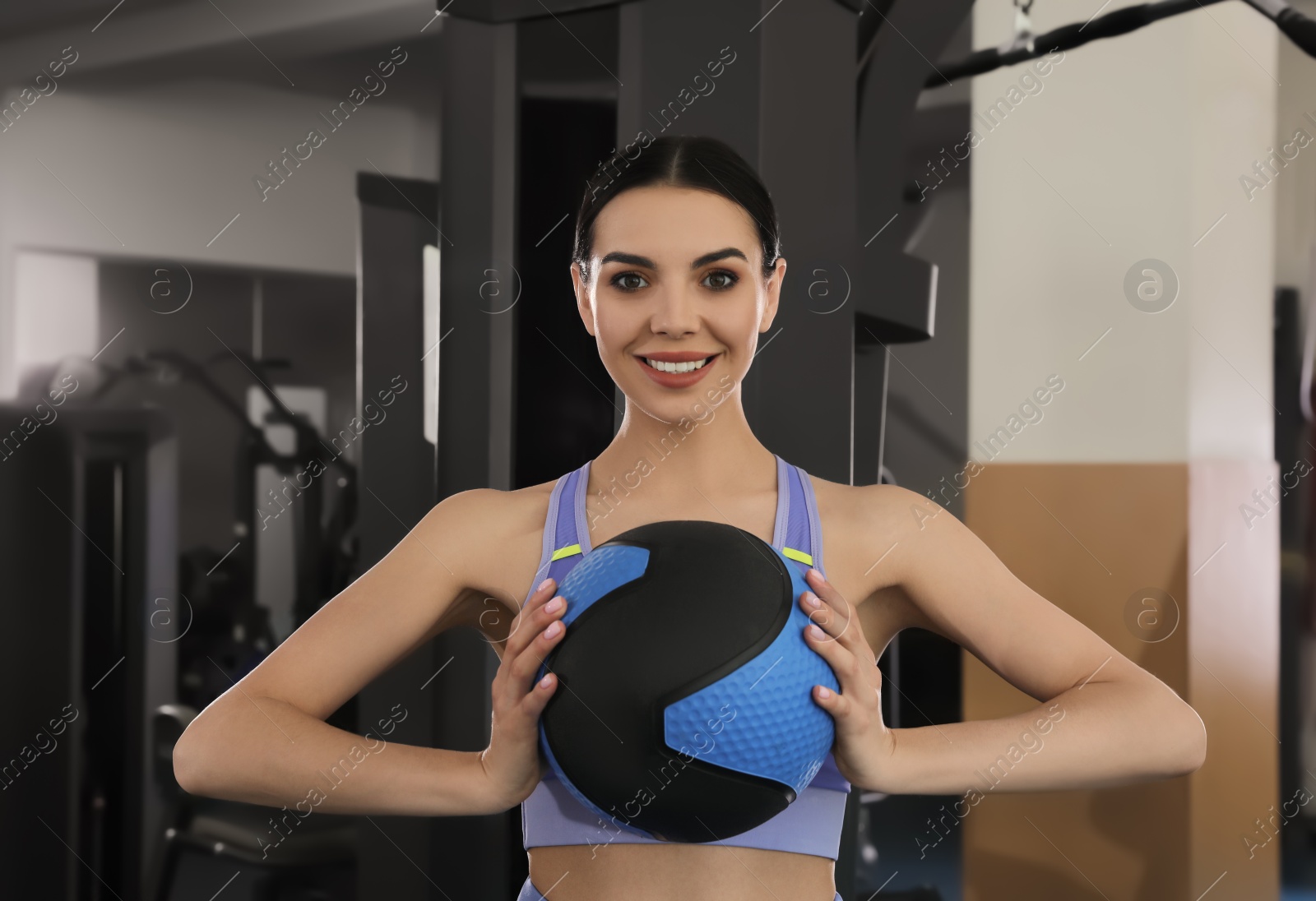 Photo of Sporty woman with medicine ball in modern gym