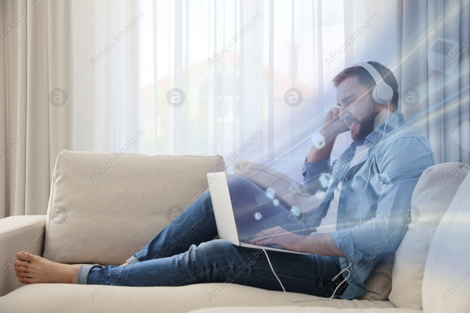 Image of Speed internet. Man using laptop on sofa at home. Motion blur effect symbolizing fast connection