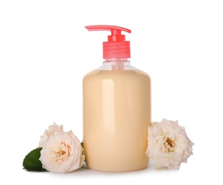 Dispenser of liquid soap and roses on white background
