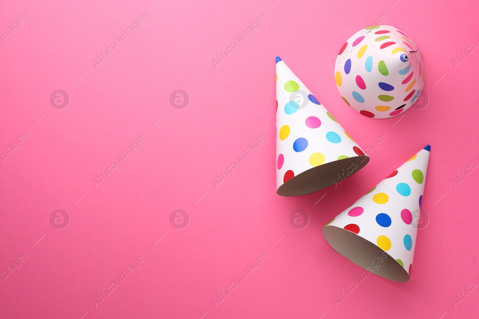 Photo of Beautiful party hats on pink background, top view. Space for text