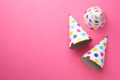 Photo of Beautiful party hats on pink background, top view. Space for text