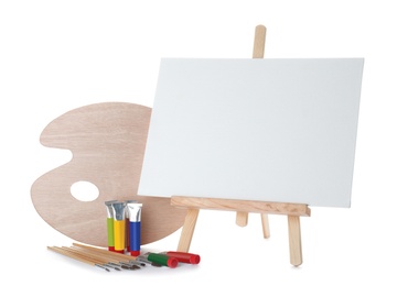 Wooden easel with blank canvas board and painting tools for children on white background